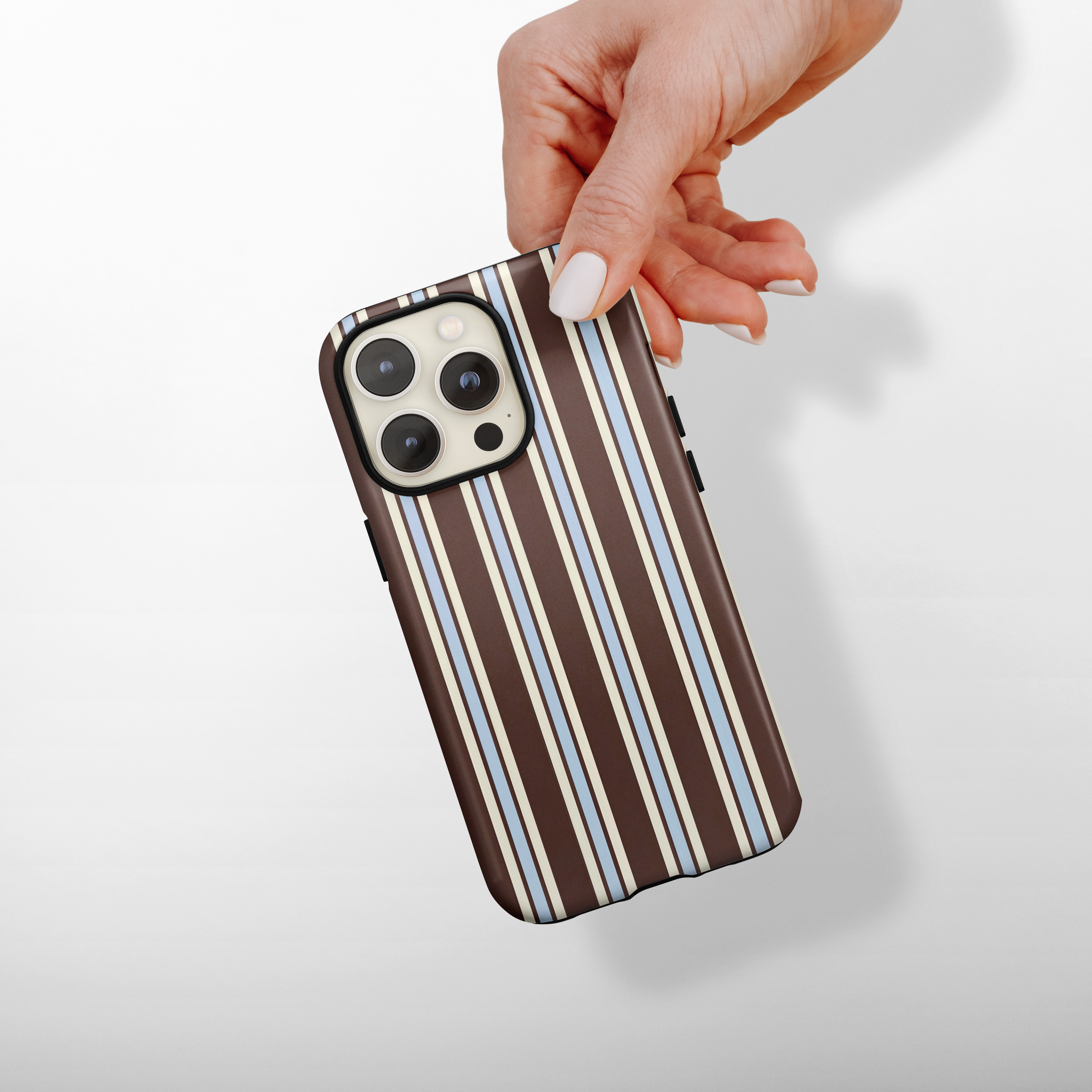 Brown and blue striped Coconut Lane Tough Phone Case held in a hand.