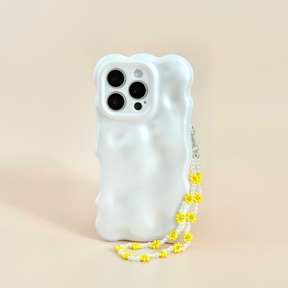 White phone case with wavy texture and a beaded sunflower phone strap, upright on a light background.