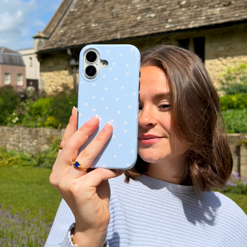 Girl taking a selfie with Blue Hearts Tough Phone Case