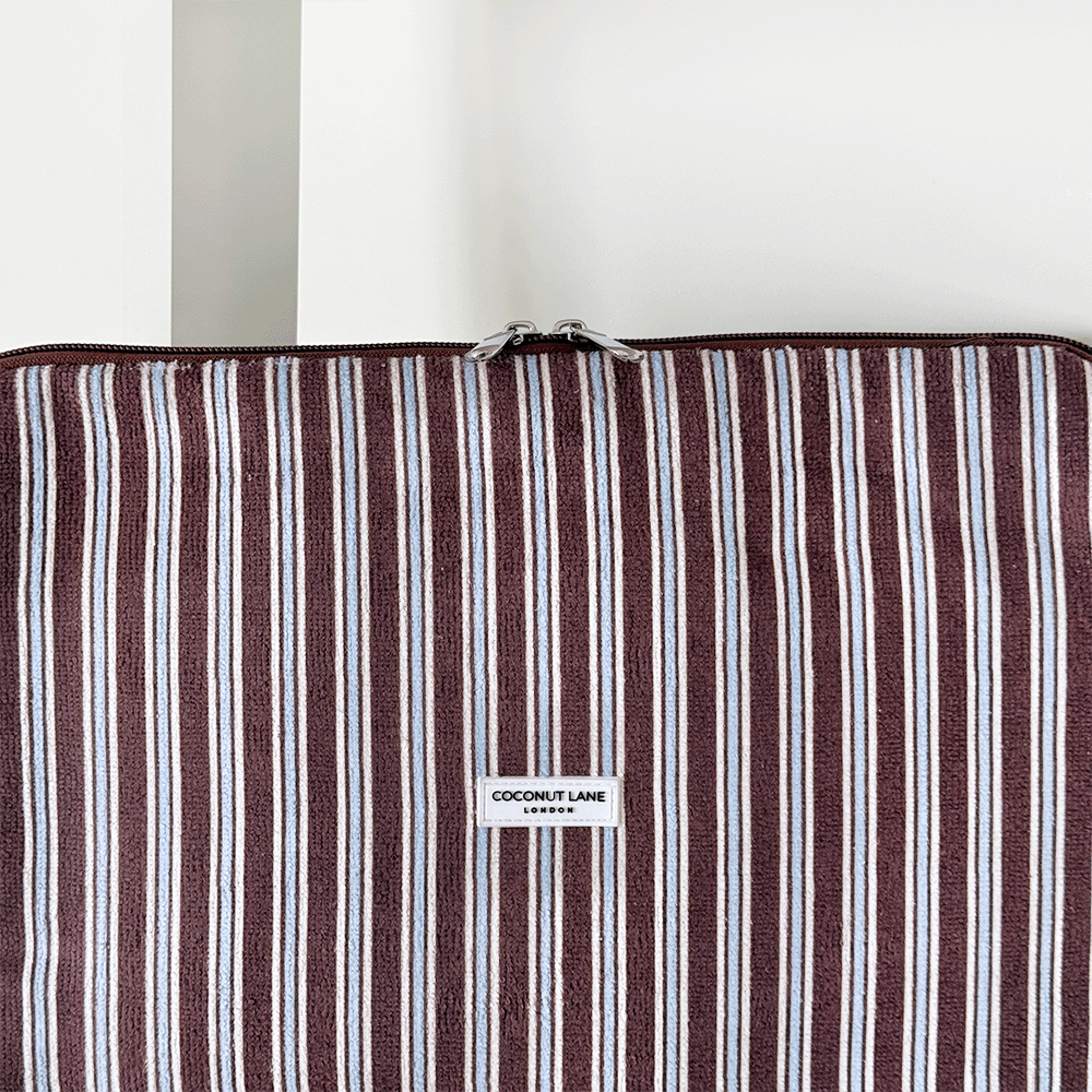 Brown, white and blue striped Laptop Sleeve with silver zip and Coconut Lane logo badge.