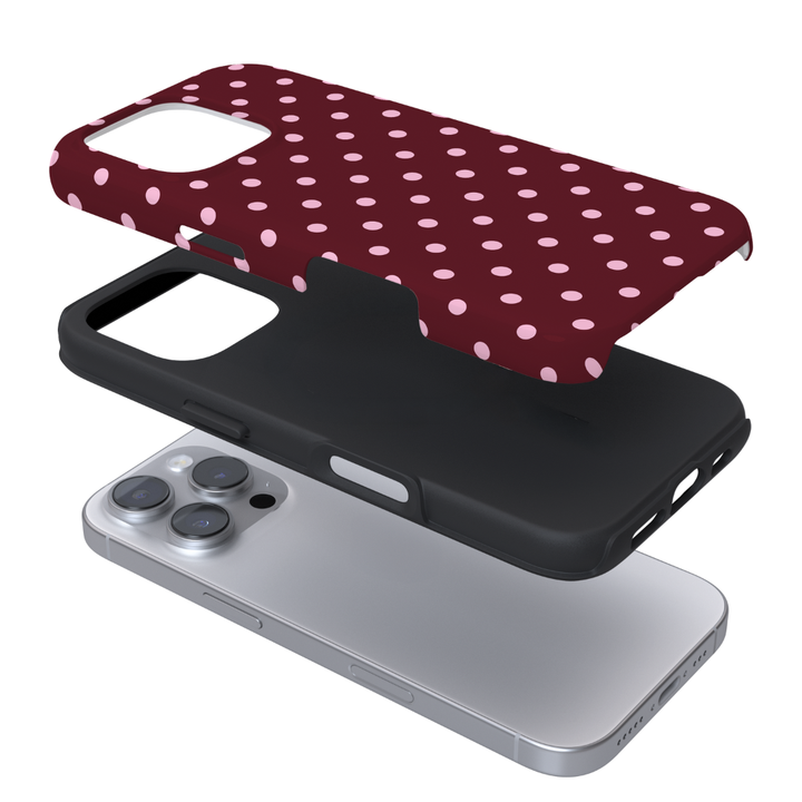 A dual-layer phone case with brown polka dots and pink spots on a white background.