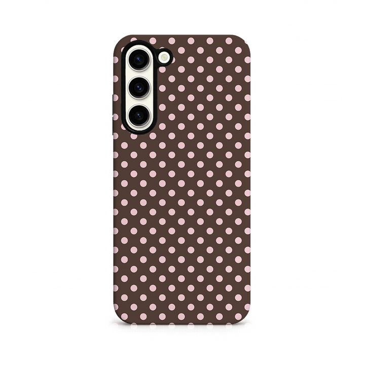 Phone case with pink polka dots on a brown background