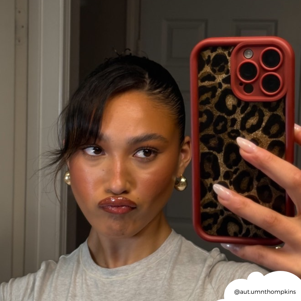 Girl pouting taking mirror selfie with the Burgundy Leopard Phone Case