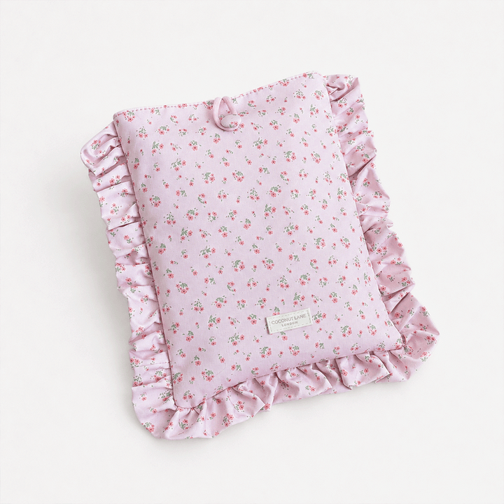 Pink floral patterned Book Sleeve with ruffled trim.