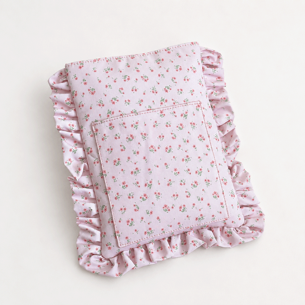 Pink floral patterned Book Sleeve with ruffled trim.