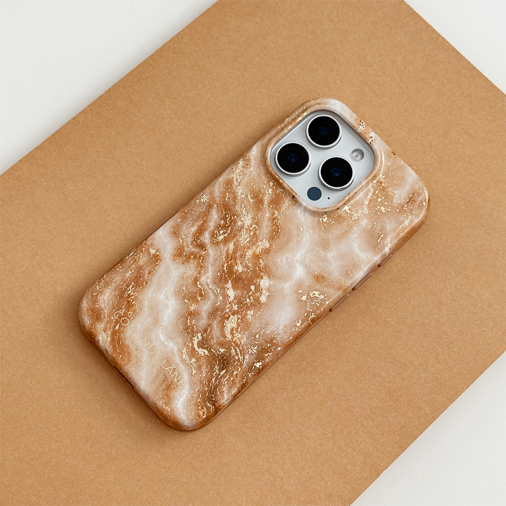 Cream and caramel marble phone case with gold veining, on a phone with three camera lenses, resting on a tan surface.