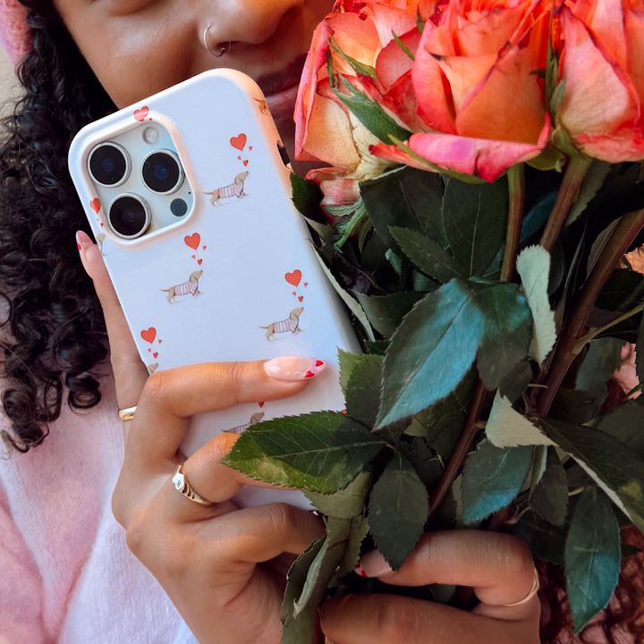 Love Paws Phone Case next to a bunch of flowers