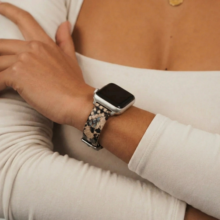 Coconut Lane vegan textured snake-print Apple Watch strap worn with a white long-sleeve top.