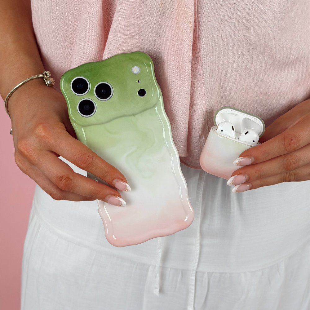 Girl holding matching strawberry matcha wavy phone case and airpods