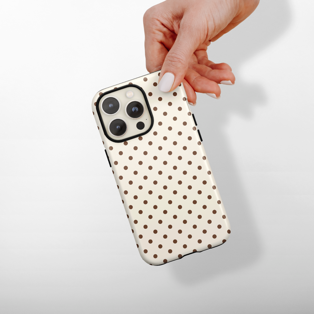 Brown polka dots on a cream background.