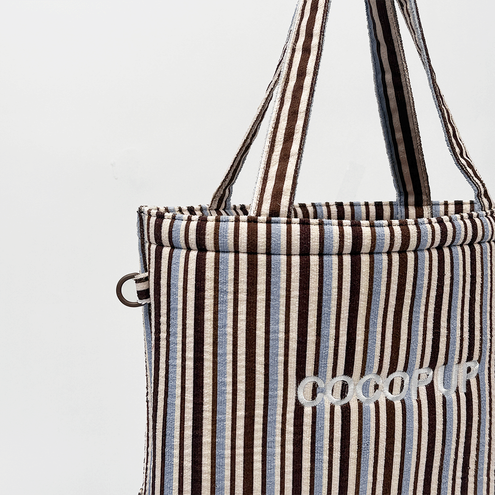 Brown and blue striped tote bag with COCOPUP embroidered on the front.