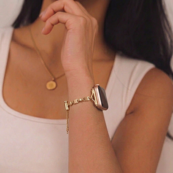 Girl wearing simple gold bracelet watch strap